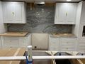 Basement kitchen stone backsplash installed